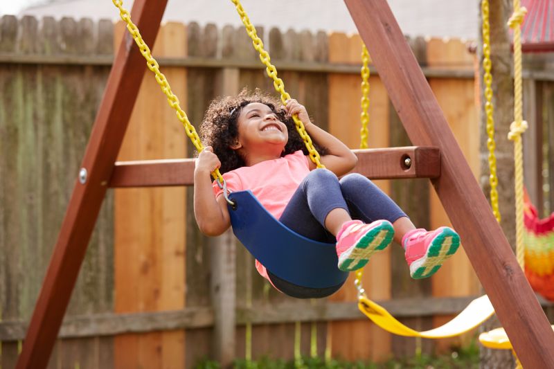 Child Playing on Swing Set